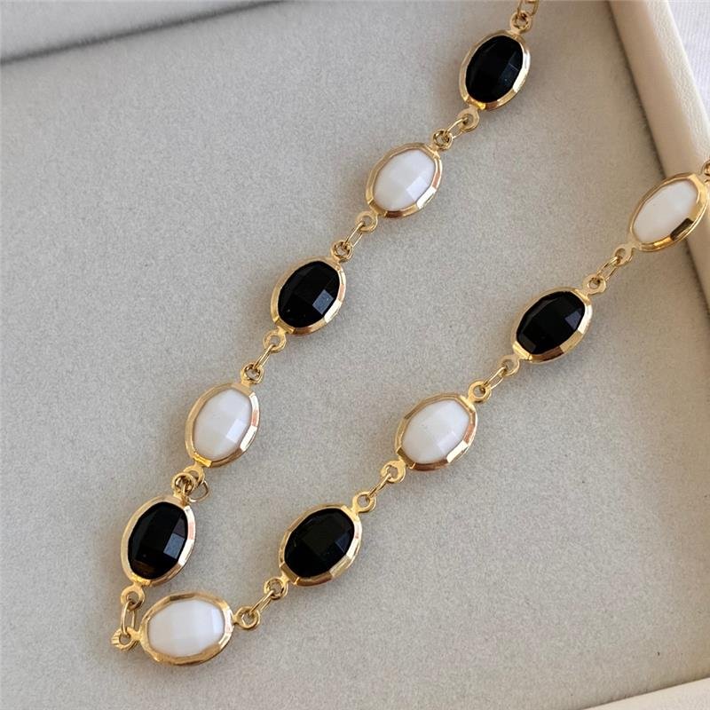 PULSEIRA PEDRA PRETA E BRANCA FOLHEADO A OURO 18K